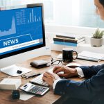 man looking stock market news computer 53876 122481