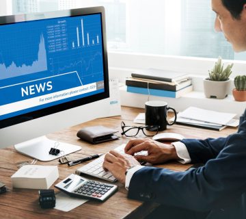 man looking stock market news computer 53876 122481